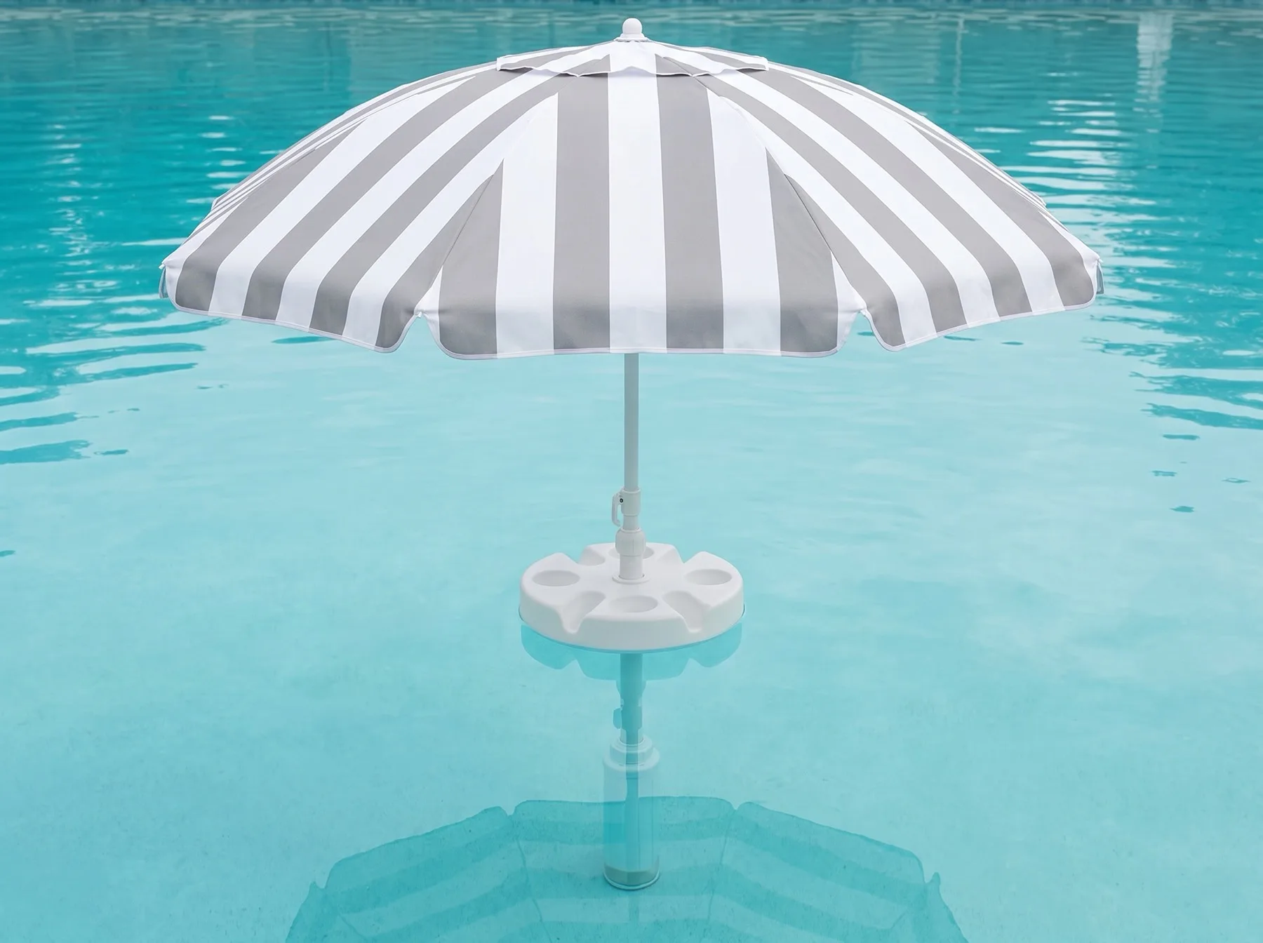 A FloatMate alone in a clear pool, its weighted column visible under the water standing on the pool floor