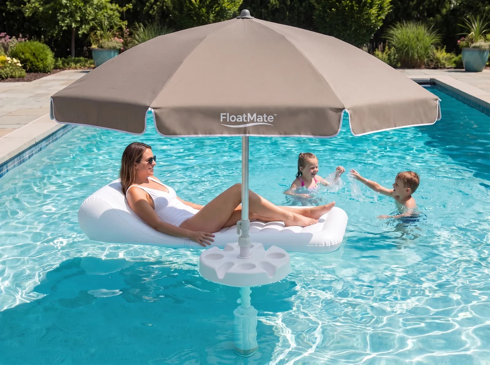 The FloatMate casting a circle of shade on the water while children swim in the sun beyond it